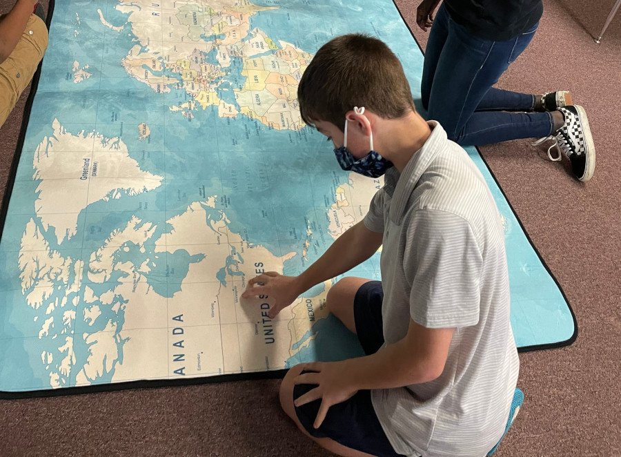 The Kurn Hattin children are having fun with their cool, new map rug, talking about where they’ve been and where they want to go someday.